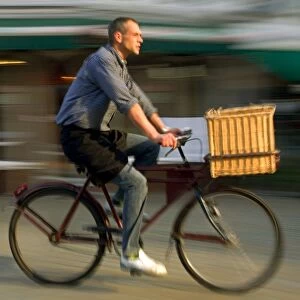 Belgium, Flanders, Antwerp; A man cycling, a common form of transport in the city
