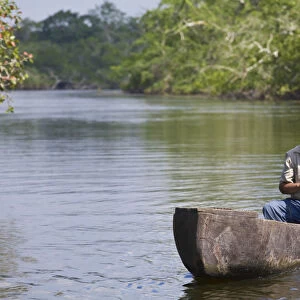 Belize, Lamanai, New River, Fisherman in dug out canoe
