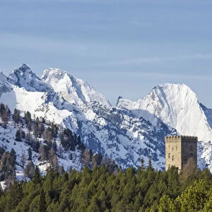 The Belvedere Tower frames the snowy peaks and Peak Badile on a spring day Maloja