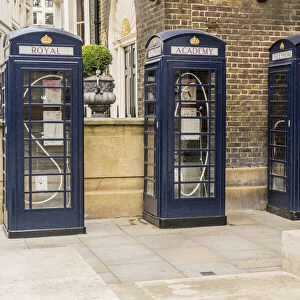 Three blue phone boxs outside the Royal Academy of Arts, designed by Max Boyla, Mayfair, London, England, UK