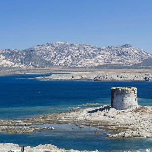 Blue sea and medieval tower surround La Pelosa Beach Stintino Asinara National Park