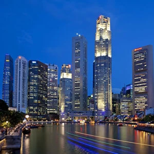Boat Quay and the Singapore River with the Financial District illuminated at dusk