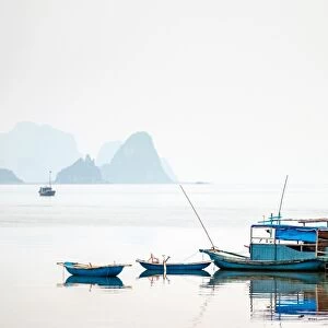Boats in Bai Tu Long Bay on a foggy day, Cai Rong, Quang Ninh Province, Vietnam