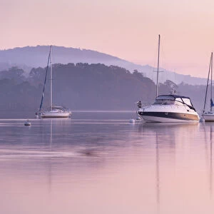 Boats moored on Lake Windermere at sunset, Bowness, Lake District, Cumbria, England