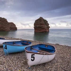 Boats pulled up on the shingle at Ladram Bay on the Jurassic Coast, Devon, England