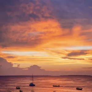 Boats on the sea in silhouette at sunset, Nungwi, Zanzibar, Tanzania Boats on the sea in silhouette at sunset, Nungwi, Zanzibar, Tanzania