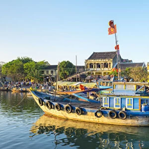 Boats on the Thu Ban'n River in front of Hoi An Ancient Town in late afternoon, Hoi An