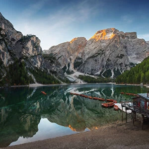 The Braies lake taking the first light of the day on a calm early autumn morning. Dolomites, Italy