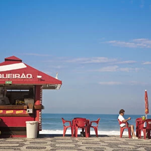 Brazil, Rio De Janeiro, Ipanema Beach, People drinking coconut juice at Kiosk