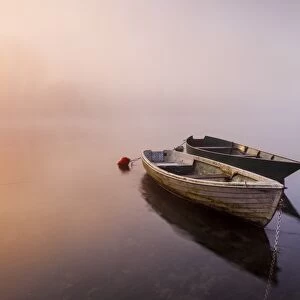Brivio, Lombardy, Italy. Two boats on the Adda river at sunrise