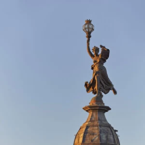 The bronze statue in homage to liberty of "La Prensa"building (Beaux Arts) at sunset on Avenida de Mayo, Monserrat, Buenos Aires, Argentina. Once headquarters of the "La Prensa"Daily Newspaper