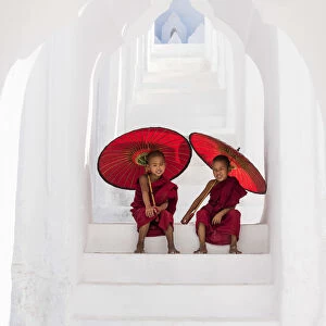 Two Buddhist novice monks on the steps of the white pagoda of Hsinbyume (Myatheindan)
