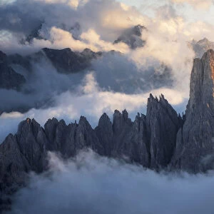 The Cadini di Misurina emerging from the sea of clouds during a stormy late summer sunset. Dolomites, Italy