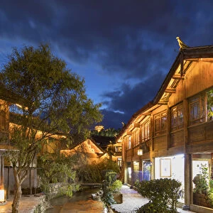 Canalside buildings at dusk, Lijiang (UNESCO World Heritage Site), Yunnan, China