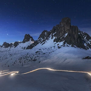 Car trail at dusk over the Giau Pass in the Dolomites, Italy