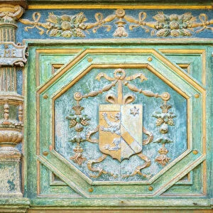 Carved painted coat of arms of Katherine Briazonnet on wooden front door of Chateau