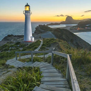 Castlepoint lighthouse lit at dusk. Castlepoint, Wairarapa region, North Island, New