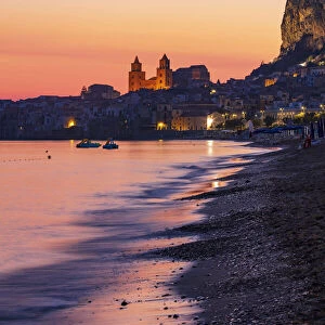 Cefaluaa, Sicily. View of the town with its baroque cathedral reflecting in the sea at