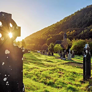 Celtic cross and St. Kevin's Church at sunrise, Early Medieval Monastic Settlement, Glendalough, County Wicklow, Ireland