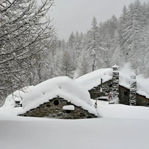 Chalet, mountain village covered by snow, Close to Ceresole Reale, Piedmont, Italy
