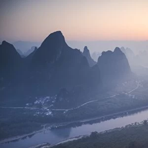 China, Guanxi, Yangshuo. Sunrise over Li river and karst peaks, elevated view