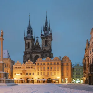 Church of our lady before Tyn at snow-covered Old Town Square at twilight in winter