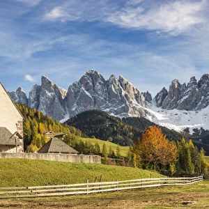 The church of the village with Odle Dolomites peaks on the background. Santa Maddalena