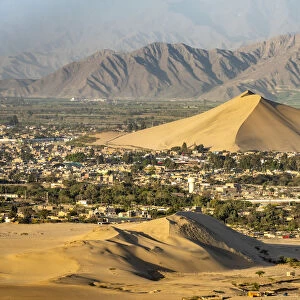 City of Ica viewed from dune at Huacachina against mountains, Ica Region, Peru