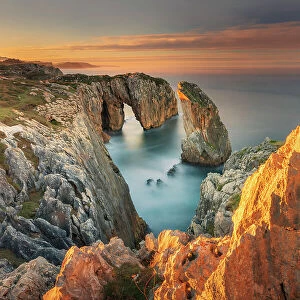 Cliff landscape with rock needle and rock arch called Pena Flecha- Spain, Asturias, Oriente, Ribadesella, Bufones de Pria - Bay of Biscay, Costa Verde