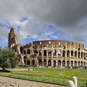 The Colosseum or Coliseum and a roman stone pavement on the foreground