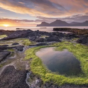 Colourful summer sunrise from the rocky shores of Gjogv on the island of Eysturoy