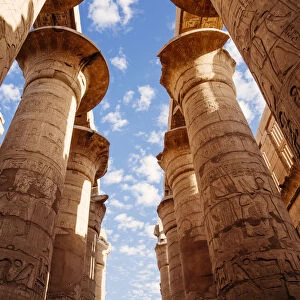 Columns and blue sky at Great hypostyle hall in the Precinct of Amun Re - Karnak Temple
