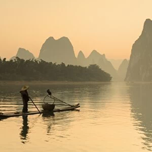 Cormorant fisherman on Li River at dawn, Xingping, Yangshuo, Guangxi, China