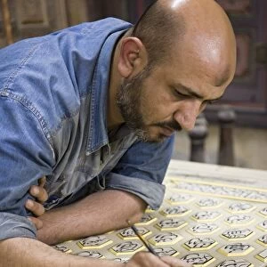 A craftsman restores a traditional house in Damascus