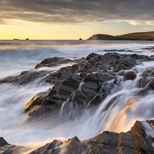 Crashing waves over the rocky shores of Boobys Bay at sunset on the North Cornwall