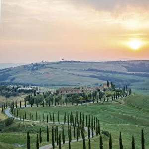 Crete Senesi, Tuscany, Italy. A lonely farmhouse with cypress and olive trees, rolling