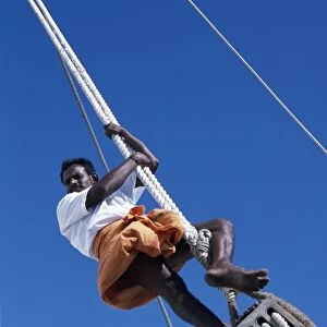 One of the crew members ofs / Y Sanjeeda up the rigging