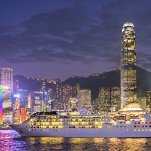 Cruisliner Silversea passing by Hong Kong Island skyline on Victoria Harbor at night
