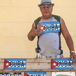 Cuba, Trinidad, Man selling Cuban car number plates