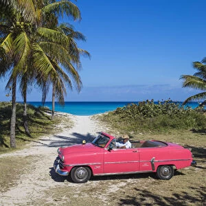 Cuba, Varadero, Pink Plymouth car on Varadero beach