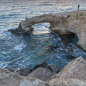 Cyprus, Ayia Napa, Cape Greco, man at sunset standing over the Love Bridge