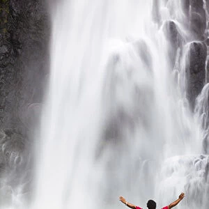 Dominica, Delices. A man stands at the base of Victoria Falls, one of the tallest