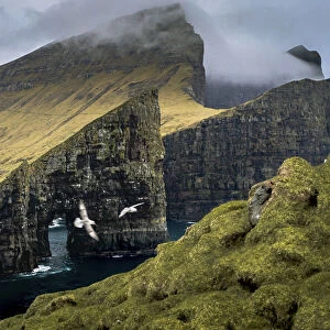 Drangarnir and the island of Vagar seen from Tindholmur. Faroe Islands