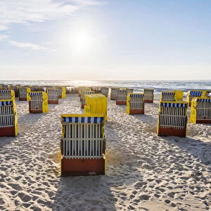 Duhnen, Cuxhaven, Lower Saxony, Germany. Yellow Strandkorbs along the beach
