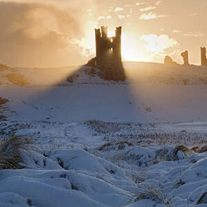 Dunstanburgh Castle at sunrise, Northumberland, England