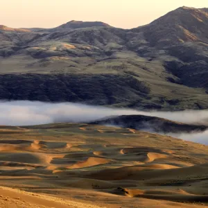 In the early morning low mist conceals the Kunene River