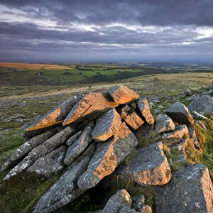 Early morning sunlight lights up the granite rocks of Belstone Tor, Dartmoor, Devon