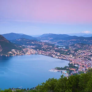 Elevated view over Lugano from Monte Bre illuminated at sunrise, Lugano, Lake Lugano