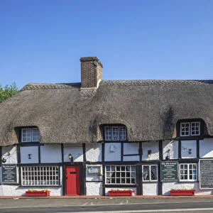 England, Hampshire, New Forest, Ringwood, 14th century Thatched Timbered Building now The Old Cottage Restaurant