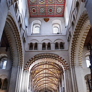 England, Hertfordshire, St. Albans. The medieval nave and vaulting in St. AlbanA¢€™s cathedral showing the red Roman bricks taken from the Roman city of Verulamium and the romanesque (Norman) arches